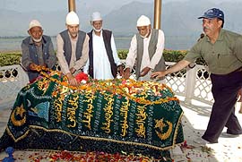 National Conference activists lay a wreath on the grave of the party founder.