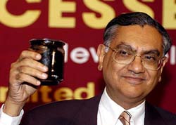 Mr P. Banerjee, Chairman and Managing Director, Gail, shows a sample of crude oil which was explored from the Cambay basin in Gujarat to mediapersons during a press conference on Exploration and Production (E&P) Successes, in New Delhi on Thursday. 