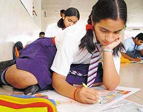 A student during an on-the-spot painting competition at a hotel in Panchkula