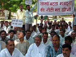 Brick-kiln owners and workers stage a dharna in protest against the order on the use of fly ash in brick production in Hisar on Thursday.