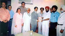 Mr N.S. Nanda presents a copy of the Punjab Tourist Guide to Mian Muhammed Aslam Iqbal, Tourism Minister, West Punjab, in Lahore, during a press conference