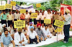 Brick-kiln owners protest in front of the Deputy Commissioners office in Ludhiana