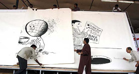 Workers open a page of the worlds largest book made in an attempt to enter the Guinness Book of World Records at the second Bangalore book festival on Friday. This book weighs more than 500 kg and consists of over100 pages.
