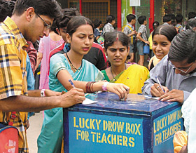Schoolteachers fill up their forms for a lucky draw held as a part of the Teacher's Week celebration at Appu Ghar in the Capital on Saturday.