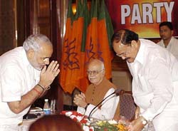 BJP President Venkaiah Naidu being welcomed by Gujarat Chief Minister Narendra Modi as Leader of the Opposition L. K. Advani looks on during the BJP Chief Ministers conference in New Delhi on Saturday. 