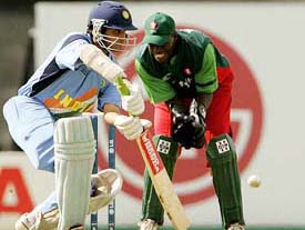 Indian captain Sourav Ganguly plays a shot as Kenyas wicketkeeper Kennedy Otieno looks on during their opening match of the Champions Trophy in Southampton 