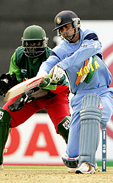 Mohammed Kaif plays a shot during his quickfire knock of 49 as wicket keeper Kennedy Otieno watches 
