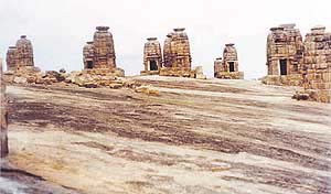 The plethora of small temples on a giant smooth rock next to the Chausath Yogini temple