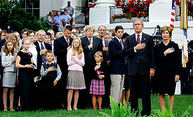 US President George W. Bush and First Lady Laura Bush with family members of victims of the September 11 attacks on the South Lawn of the White House on Saturday