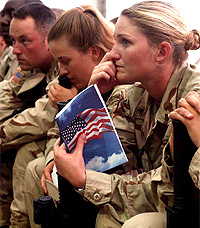 US soldiers pay attention during a memorial ceremony at Bagram Air Base