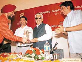 Mr Raghunath Sahai Puri, Punjab Minister for Housing and Urban Development, being honoured at a seminar