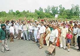 Former employees of Punwire block traffic at Balongi Chowk in Mohali on Sunday