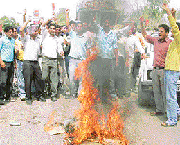 Students of two engineering colleges burn an effigy of the Registrar of PTU in support of demands at Landran, near Mohali, on Tuesday.