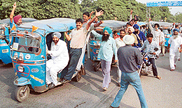 Auto-rickshaw drivers in a cheerful mood after calling off their strike in Mohali on Tuesday.