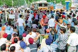 Students of Guru Nanak Dev Engineering College, Ludhiana, block traffic on the Ludhiana-Malerkotla road in protest against the alleged manhandling of a student