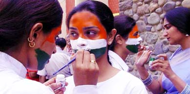 Students of the Government College for Women give finishing touches to their faces before participating in the Hindi Divas celebrations