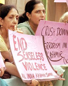 Members of the All-India Kashmiri Samaj carry placards while staging a protest to observe Kashmiri Martyrs Day in New Delhi