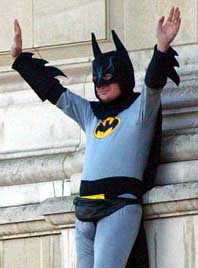 A fathers' rights campaigner dressed as Batman protests on a balcony at Buckingham Palace in London on Monday.