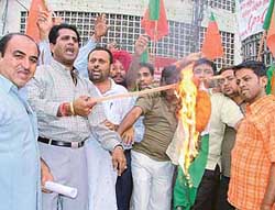 BYJM workers set afire a Congress flag at Clock Tower, Ludhiana, on Wednesday. 