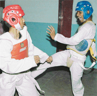 Sandeep of Kendriya Vidyalaya, Jhajjar, attacks Suraj Joshi of KV, Chandimandir, in taekwondo final at Kendriya Vidyalaya, Sector 31, Chandigarh, on Thursday.
