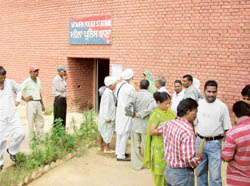 People wait for their turn for counselling outside the police station