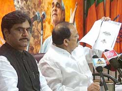 BJP president Venkaiah Naidu along with Gopinath Munde addresses a press conference after BJP election committee meeting on Maharashtra and Arunachal Pradesh at the BJP headquarters in New Delhi on Thursday. 