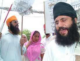 Raagi Ranjit Singh, his wife Mrs Manjit Kaur and other visually challenged persons protest outside the Chhehrta police station near Amritsar