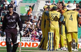 Australian players celebrate the dismissal of New Zealands Nathan Astle during their ICC Champions Trophy match at the Oval in London on Thursday