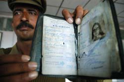 A policeman shows the passport of Swedish woman Margot Lydia Aulikki recovered from Jot Glacier after 23 years in Shimla on Friday. 