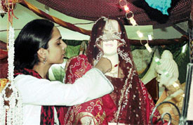A student of Pinnacle Fashion Institute gives finishing touches to a dress at an exhibition in Ludhiana