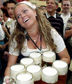 A waitress carries one-litre beer mugs during the opening day of the Oktoberfest in Munich, Germany