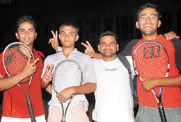 Tennis players of DAV College, Sector 10, Chandigarh with their coach Robin Kumar in jubilant mood after they won the Panjab University Inter-College Tennis Championship.