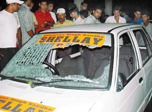 Smashed wind-screen of the car in which he was travelling at the time of incident. 