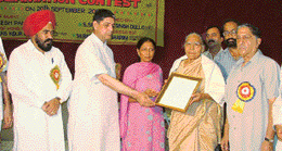 Mr Rakesh Panday, State Minister for Science and Technology, honours Mrs Krishna Singh, the widow of journalist Mohan Lal Singhi at a function organised to commemorate the 80th birth anniversary of the journalist at Khanna on Monday.