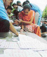 A student of the Veterinary Department signs her name in blood on a memorandum for the Chief Minister in front of the PAU Vice-Chancellors office in Ludhiana on Monday.