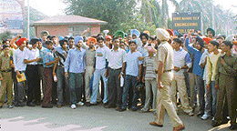 Students of GNEC being restrained from entering the college.