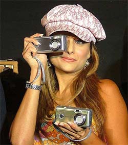 Bollywood actress Amrita Arora poses with Canon digital cameras at a press briefing in New Delhi