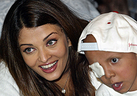 Bollywood star Aishwarya Rai interacts with a young cancer patient in Mumbai on Tuesday