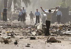 An Iraqi man shouts at police officers and US soldiers