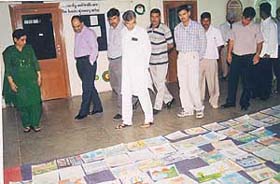 Mr Pawan Kumar Bansal walks past the paintings displayed during the contest organised by the Mahak Foundation