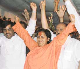 BJP leader Uma Bharti along with Delhi BJP president Harshavardhan waves to her supporters as her Tiranga Yatra enters New Delhi