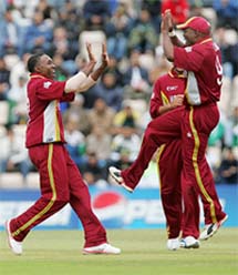 West Indies bowler Dwayne Bravo celebrates with Brian Lara after the dismissal of Pakistans Shoaib Malik during their ICC Champions Trophy semifinal at the Rose Bowl, Southampton