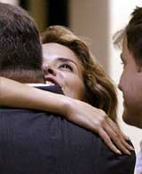 Fallen Mexican pop star Gloria Trevi is embraced by an unidentified man after she was freed from prison in Chihuahua 