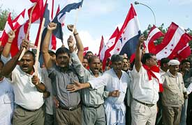Volunteers from the four political parties shout anti-monarch slogans