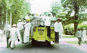 Farmers travel in a tractor-trailer to go to the kisan mela at Punjab Agricultural University in Ludhiana on Thursday.