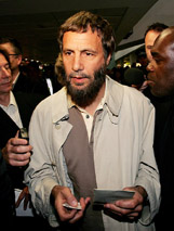 Muslim convert and former pop star Britain's Cat Stevens, known as Yusuf Islam, returns to Heathrow airport, London, on Thursday. 
