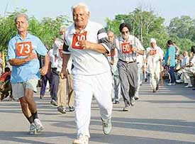 Senior citizens participate in a brisk walk competition held at Sukhna Lake in Chandigarh on Friday.
