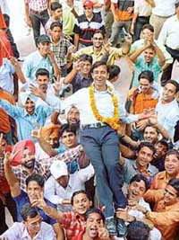 President-elect of the Panjab University Campus Students Council Rajwinder Singh Lucky (garlanded), lifted by supporters on the campus in Chandigarh on Friday. 