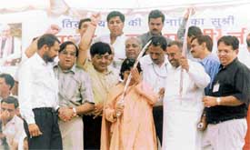 Senior BJP leader Uma Bharti bows to the sword which was presented to her by party activists as her Yatra entered Ludhiana
