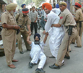 Activists of SAD(A) being dragged by the police as they resort to a black flag protest during Uma Bhartis Tiranga Yatra in Amritsar 